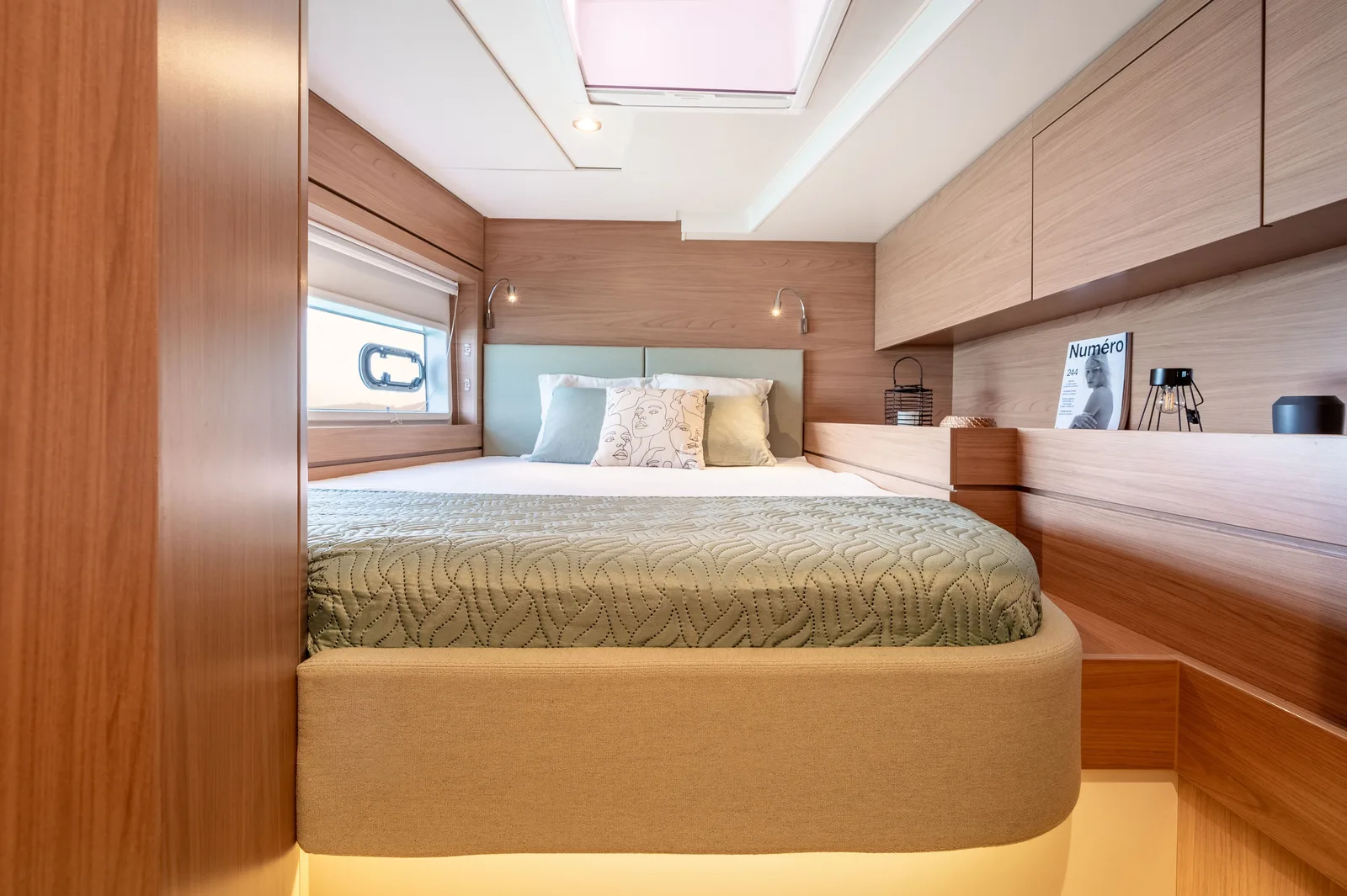 Bali 4.6 double cabin with a hull window, overhead hatch and wooden storage cupboards