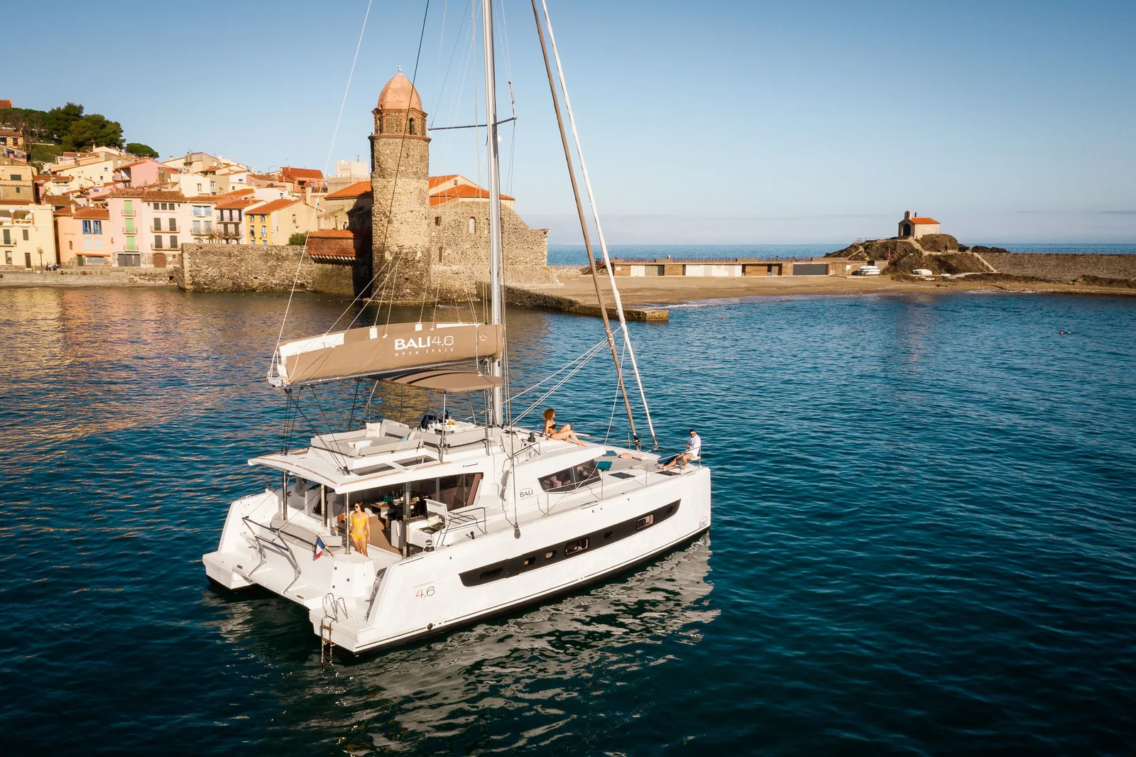Bali 4.6 catamaran at anchor in Collioure, showing the aft deck and raised lounge